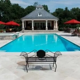 Beautiful inground pool with outdoor seating and umbrellas in Long Island.