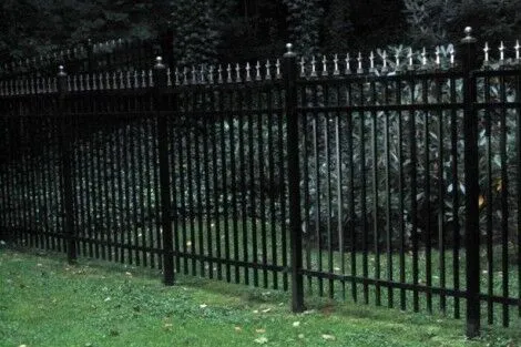 Durable black metal fencing installed for privacy and security in Long Island outdoor spaces. Black metal fence with decorative finials on Long Island property.