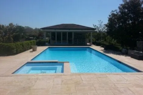Elegant inground pool with hot tub and outdoor seating area in Long Island, perfect for outdoor living and relaxation. Beautiful inground pool with hot tub and outdoor lounge area in Long Island.