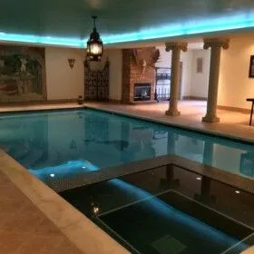 Indoor swimming pool with ambient lighting and elegant decor.