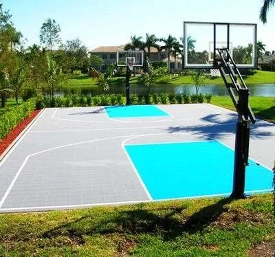 Beautiful outdoor basketball court with inground pool and lush landscaping in Long Island residential setting. Residential outdoor basketball court with inground pool in Long Island.