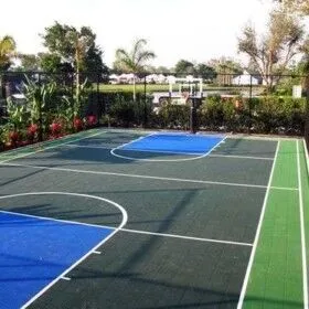 Basketball court with outdoor furnishings in Long Island residential backyard.
