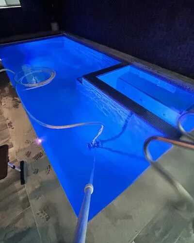 Luxury inground pool with lighting and outdoor furniture in Long Island, perfect for outdoor living and relaxation. Inground pool with blue lighting and outdoor furnishings in Long Island.