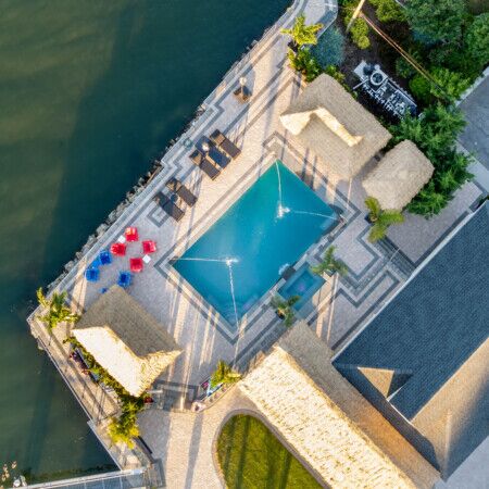 Aerial view of a Long Island pool area with outdoor furniture and landscaping.