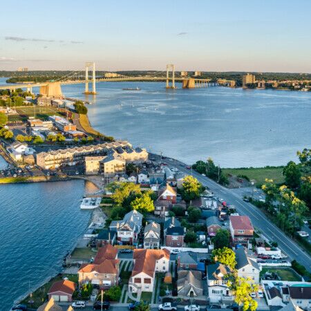 Aerial view of Long Island with water, homes, and outdoor furnishings.