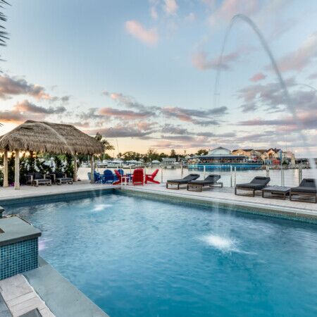 Luxury inground pool with outdoor seating and water features in Long Island.