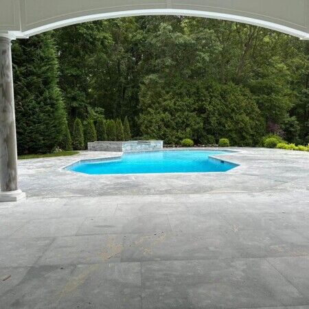 Elegant backyard with inground pool and outdoor furnishings in Oyster Bay, Long Island. Beautiful inground pool with patio and lush greenery in Oyster Bay.