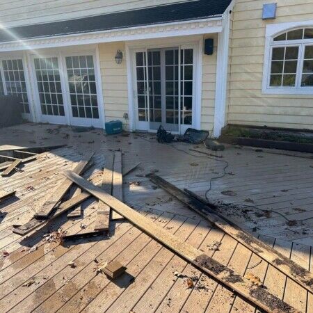 Construction of a new outdoor deck with sliding glass doors in Oyster Bay, enhancing backyard living space. Building a new outdoor deck with sliding glass doors in Oyster Bay.
