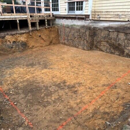 Preparation for inground pool installation with marked boundaries in a Long Island backyard. Excavated backyard for inground pool installation in Long Island.