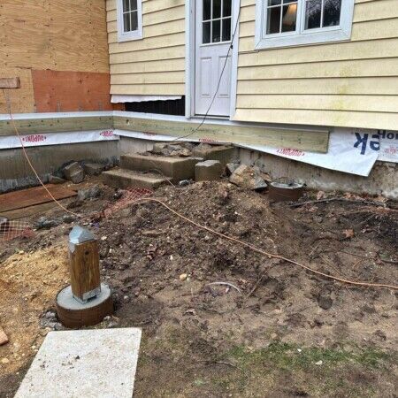 Ongoing construction for an inground pool at a residential property in Long Island, showing foundation preparation and site work. Construction site for inground pool with foundation work in progress.