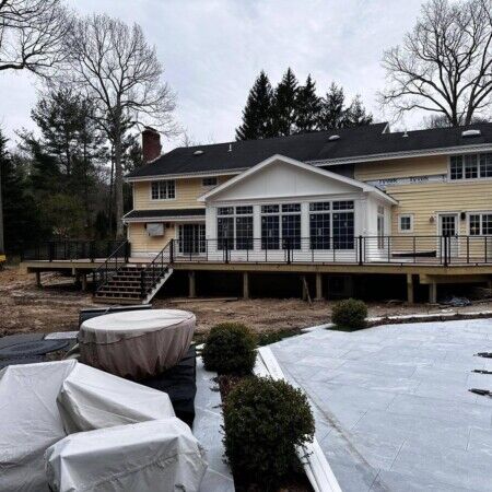 Newly installed inground pool with outdoor furnishings in Oyster Bay backyard, perfect for outdoor living and entertaining. Beautiful backyard with new inground pool and outdoor furnishings in Oyster Bay.