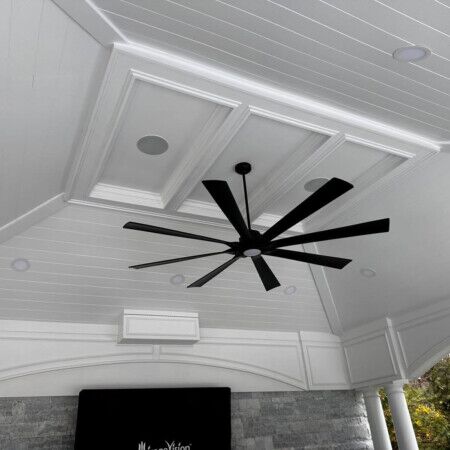 Elegant indoor ceiling featuring a black ceiling fan, recessed lighting, and decorative ceiling panels for a stylish look. Modern indoor ceiling with fan, recessed lights, and decorative ceiling panels.