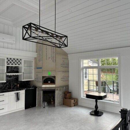 Spacious living area featuring a fireplace, large window, and balcony overlooking outdoor space. Bright living room with fireplace, large window, and balcony access.