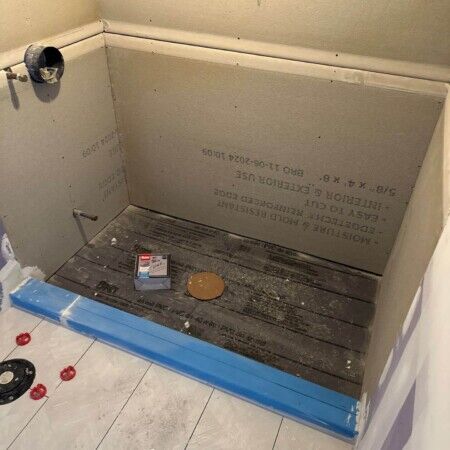 Construction of inground pool with wall and plumbing setup in progress.