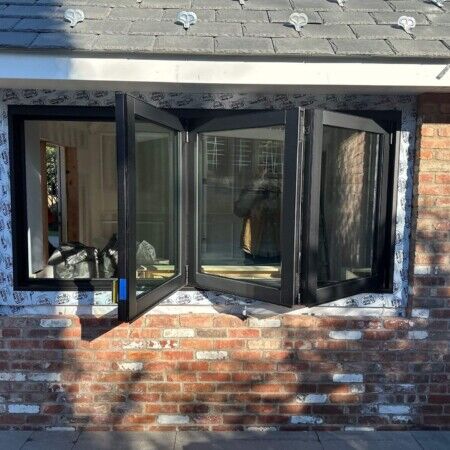 Window installation on brick wall for Manhasset cabana project.