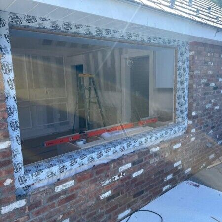 Construction of a cabana in progress at Manhasset property with window installation.