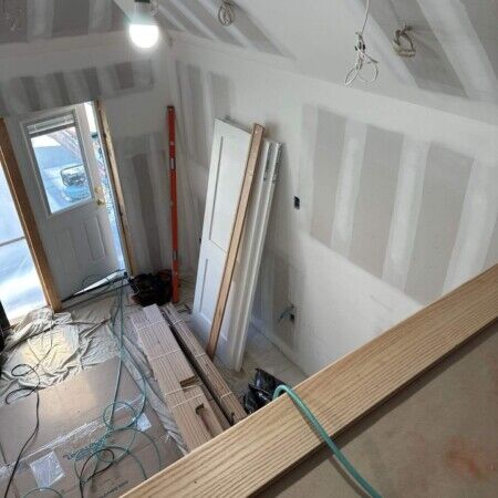 Interior view of ongoing cabana construction in Manhasset with drywall and electrical wiring.