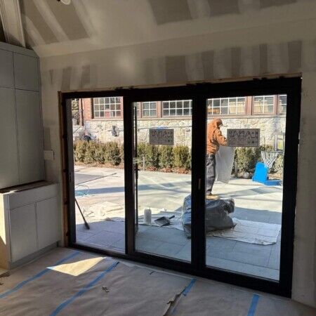 Construction of Manhasset cabana with large glass sliding doors underway.