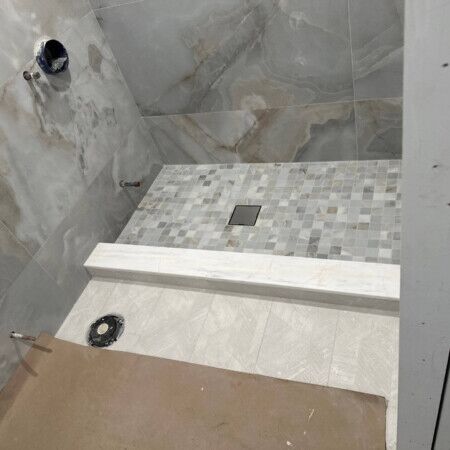 Inground pool area with tile and drain in progress in Manhasset.