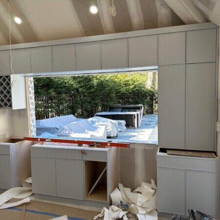 Construction of a modern cabana with cabinetry and outdoor view in Manhasset.