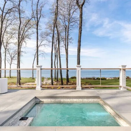 Scenic view of Lloyd Harbor with outdoor pool and furnishings.