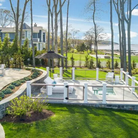Beautiful backyard with inground pool, outdoor furnishings, and scenic water view.