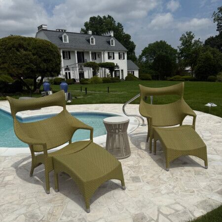 Elegant poolside outdoor furnishings with a large house in the background on Long Island. Poolside outdoor furniture with a house in the background on Long Island.