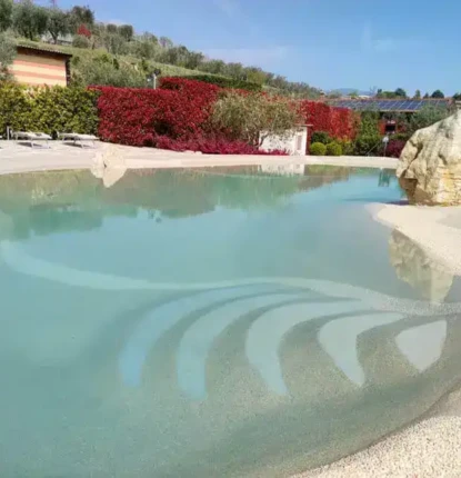 Luxury inground pool with water features and outdoor seating in Long Island, perfect for outdoor living. Beautiful inground pool with water features and outdoor furnishings in Long Island.