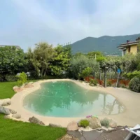 Elegant backyard with in-ground pool, outdoor furniture, and scenic mountain views in Long Island. Beautiful backyard with in-ground pool, outdoor furnishings, and lush landscaping.