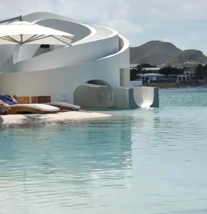 Luxury outdoor pool area with a white slide and lounge chairs in Long Island, perfect for outdoor relaxation. Modern white pool slide and outdoor furniture in Long Island setting.