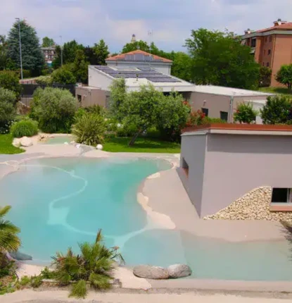Beautiful inground pool with surrounding greenery and outdoor furnishings.