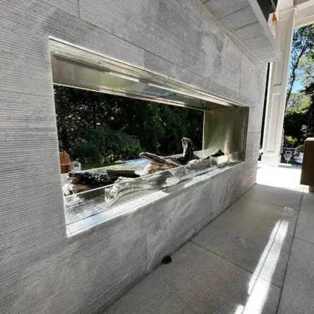 Stylish indoor fireplace with a minimalist design, perfect for modern living spaces. Contemporary indoor fireplace with sleek gray stone finish and glass front.