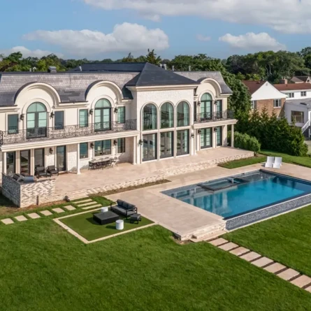Elegant Long Island estate with inground pool and outdoor furnishings.