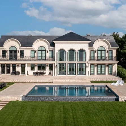Elegant mansion with outdoor pool and lush lawn in Long Island.