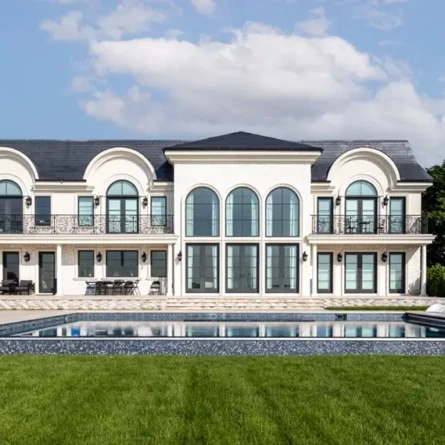 Elegant mansion with large pool and outdoor furnishings in Long Island.