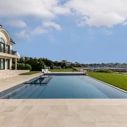 Luxury inground pool with scenic waterfront view on Long Island.
