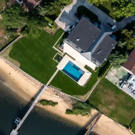 Aerial view of a Long Island home with a pool and outdoor furnishings.