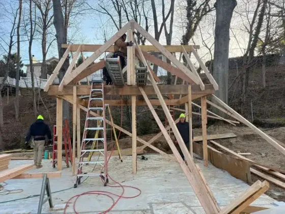 Construction of a pool house with wooden framework in progress on Long Island.