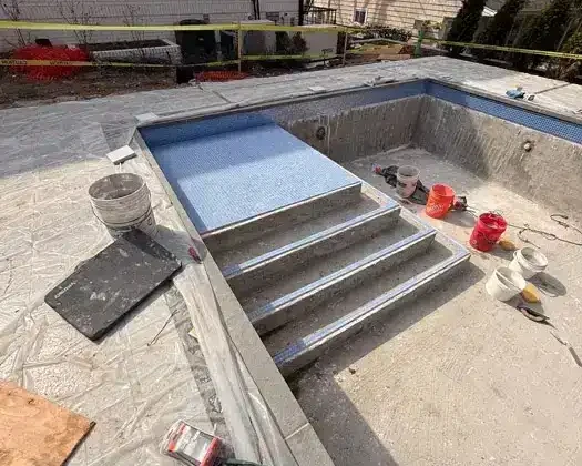 Inground pool with steps under construction in Long Island.