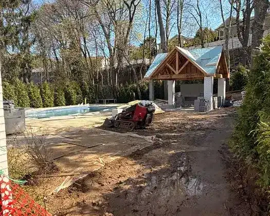 Inground pool construction site with outdoor pavilion in progress in Flower Hill.