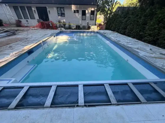 Newly installed inground pool with surrounding deck in Long Island.