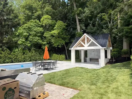 Beautiful outdoor pool area with a cabana and seating in Long Island.