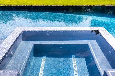 Custom inground pool with spa, perfect for outdoor relaxation and entertaining in Long Island. Luxury inground pool with spa and outdoor furnishings in Long Island.