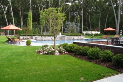 Elegant backyard featuring a custom inground pool, outdoor seating, and vibrant landscaping for outdoor living. Beautiful backyard with inground pool, outdoor furniture, and lush landscaping.