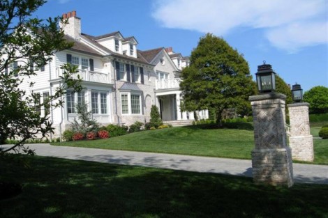 Beautiful Long Island estate with lush landscaping, outdoor lighting, and a grand architectural design. Elegant Long Island mansion with landscaped yard and outdoor lighting.