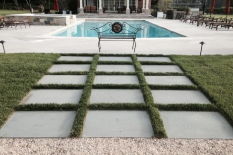 Elegant inground pool with surrounding outdoor furnishings and landscaping in Long Island, perfect for outdoor living. Beautiful inground pool with outdoor seating and landscaping in Long Island.
