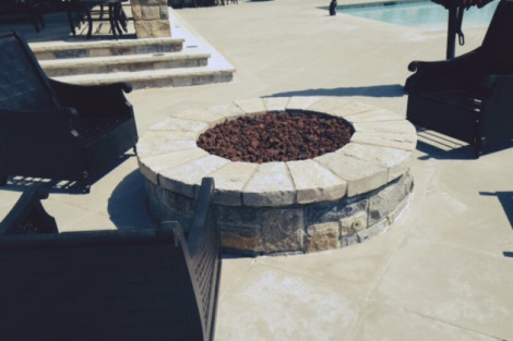 Elegant stone fire pit with surrounding seating area enhances outdoor living space. Stone fire pit with seating area in outdoor patio setting.
