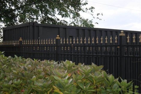 Elegant black metal fence with gold accents installed by All Island Group in Long Island. Black metal fence with decorative gold finials on Long Island property.