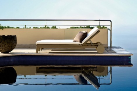 Relaxing outdoor pool lounge chair with cushion on pool deck, perfect for outdoor living and relaxation. Luxury outdoor pool lounge chair with cushion on pool deck.