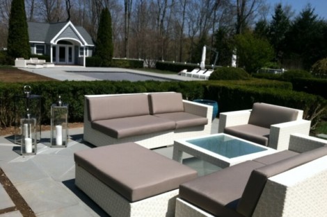 Elegant outdoor furniture setup with lounge chairs, fire pits, and a pool, perfect for outdoor living and entertaining. Modern outdoor furniture set with lounge chairs and fire pits near pool.
